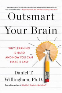 Hold a copy of Outsmart Your Brain